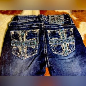 Miss Me Blue Jeans that are dark denim washed I